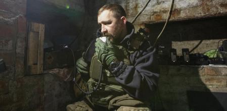 A Ukrainian service member uses a radio station in a shelter near their position at a frontline, amid Russia's attack on Ukraine, in Bakhmut, Donetsk region, Ukraine January 1, 2023.  REUTERS/Anna Kudriavtseva     TPX IMAGES OF THE DAY