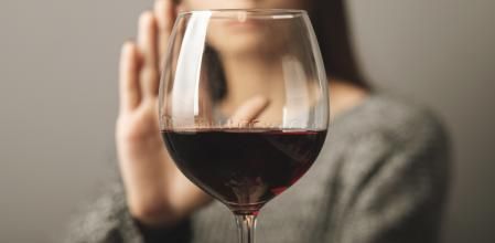 reject liquor,stop alcohol, teenager girl shows a sign of refusal of wine