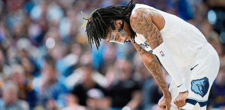 Memphis Grizzlies guard Ja Morant reacts as the team trails the Denver Nuggets during the second half of an NBA basketball game Friday, March 3, 2023, in Denver. (AP Photo/David Zalubowski)