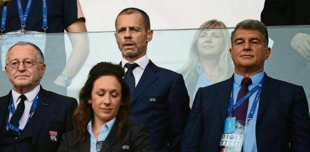(Centre-row L to R) Olympique Lyonnais' President Jean-Michel Aulas, UEFA President Aleksander Ceferin, and FC Barcelona President Joan Laporta attend the UEFA Women�s Champions League Final football match between Spain's Barcelona and France's Lyon at the Allianz Stadium in the Italian city of Turin on May 21, 2022. (Photo by FRANCK FIFE / AFP)