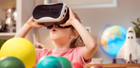 Little girl wearing virtual reality glasses