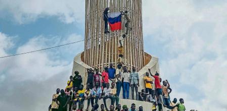 Supporters of Niger's ruling junta hold a Russian flag at the start of a protest called to fight for the country's freedom and push back against foreign interference in Niamey, Niger, Thursday, Aug. 3, 2023. The march falls on the West African nation's independence day from its former colonial ruler, France, and as anti-French sentiment spikes, more than one week after mutinous soldiers ousted the country's democratically elected president. (AP Photo/Sam Mednick)