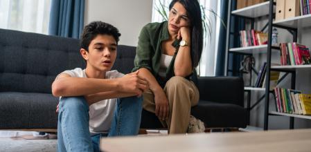 Mother and son sitting after quarrel at home