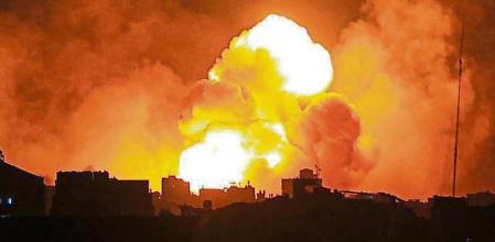 EDITORS NOTE: Graphic content / TOPSHOT - Fire and smoke rise above buildings in Gaza City during an Israeli air strike, on October 8, 2023. The death toll surged to almost 1,000 since Palestinian militant group Hamas launched its massive surprise attack on Israel with a barrage of rockets and a massive ground assault, officials on both sides said on October 8. (Photo by IBRAHIM HAMS / AFP)