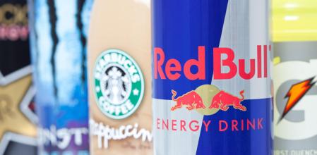 Fort Worth, TX, United States of America - May 2, 2011: Closeup of Red Bull along with other energy drinks. Red Bull, Starbucks coffee, Monster Energy, and Gatorade are all drinks that are commonly sold in the U.S.A. Red Bull is an Austrian energy drink created by Dietrich Mateschitz.