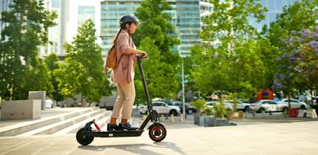 Una persona circulando con un patinete eléctrico.