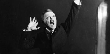 1925: Adolf Hitler (1889 - 1945), leader of the National Socialist German Workers' Party (NSDAP), strikes a pose for photographer Heinrich Hoffmann whilst listening to a recording of his own speeches. After seeing the photographs, Hitler ordered Hoffmann to destroy the negatives, but he disobeyed. (Photo by Heinrich Hoffmann/Keystone Features/Getty Images)