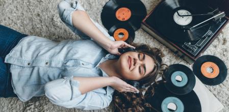 Una mujer escuchando música con un tocadiscos.