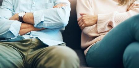 Cropped shot of an unrecognizable mature couple sitting on the sofa with their arms folded after an argument