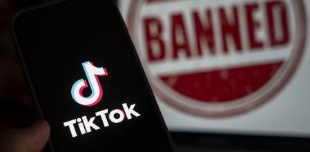April 25, 2024: In this photo illustration, logo of Tiktok is displayed on mobile phone screen next to ban sign, in Guwahati, India 25 April 2024. US President Joe Biden signs law to ban Chinese-owned TikTok unless sold to US company.