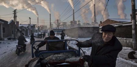Daily Life, 1st prize singles, World Press Photo Awards (Kevin Frayer - China's Coal Addiction)Chinese men pull a tricycle in a neighborhood next to a coal-fired power plant in Shanxi, China, November 26, 2015. A history of heavy dependence on burning coal for energy has made China the source of nearly a third of the world's total carbon dioxide (CO2) emissions, the toxic pollutants widely cited by scientists and environmentalists as the primary cause of global warming. REUTERS/Kevin Frayer via WPP EDITORIAL USE ONLY. NO RESALES. NO ARCHIVE