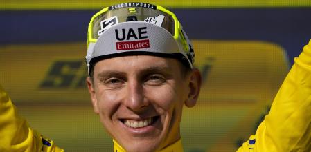 Slovenia's Tadej Pogacar, wearing the overall leader's yellow jersey, celebrates on the podium after the twentieth stage of the Tour de France cycling race over 132.8 kilometers (82.5 miles) with start in Nice and finish in La Couillole pass, France, Saturday, July 20, 2024. (AP Photo/Jerome Delay)