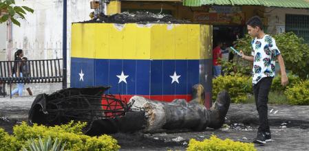 A destroyed statue of the late Venezuelan President Hugo Chavez lays next to its base in Valencia, Venezuela, Tuesday, July 31, 2024, the day after people protested the official election results that certified Chavez's protege, current President Nicolas Maduro, as the winner. (AP Photo/Jacinto Oliveros)