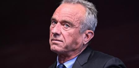 (FILES) Independent presidential candidate Robert F. Kennedy Jr. watches his running mate Nicole Shanahan speak during a campaign event at the Henry J. Kaiser Event Center in Oakland, California, on March 26, 2024. A judge has ruled that presidential candidate Robert F. Kennedy Jr. falsely claimed his residency was in New York and barred him from ballots in the US state, a court document filed on August 13, 2024 revealed. (Photo by JOSH EDELSON / AFP)