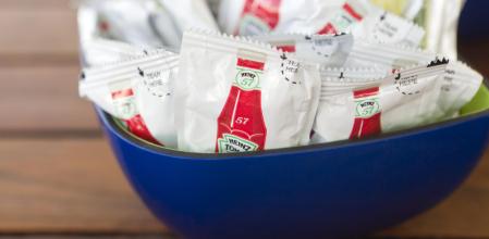 Bowl containing condiment packets of Heinz 57 ketchup on restaurant table. The H.J. Heinz Company (NYSE: HNZ) is a food company with its world headquarters in Pittsburgh, Pennsylvania and is best known for its ketchup. A condiment sachet or packet is a small sachet made from plastic, tin foil or mylar which contains a small portion of condiment. Source: Wikipedia