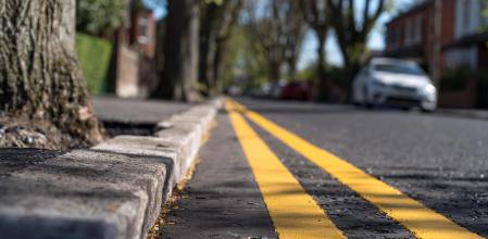 Las líneas amarillas continuas junto al bordillo simbolizan la prohibición de aparcar en la zona