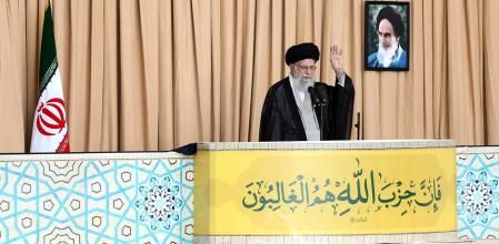 Ali Jamenei, con un fusil Kalashnikov a su lado, cuyo cañón asoma por el balcón