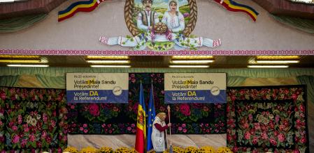 A woman mops a stage before an electoral rally of Moldova's President Maia Sandu in Magdacesti, Moldova, Thursday, Oct. 17, 2024, who is seeking a second term in office ahead of a presidential election and a referendum of whether to enshrine in Moldova's Constitution its path to European Union membership taking place on Oct. 20. (AP Photo/Vadim Ghirda)