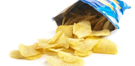 heap of potato crisps on white background