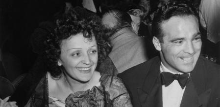 22nd September 1940: French singer Edith Piaf and French boxer Marcel Cerdan smile while sitting at a dining table at the Versailles nightclub, New York City. (Photo by Hulton Archive/Getty Images)