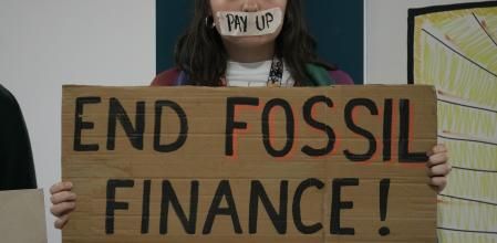 A demonstrator holds a sign that reads 