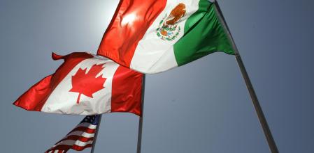 FILE - National flags representing the United States, Canada, and Mexico fly in the breeze in New Orleans where leaders of the North American Free Trade Agreement met on April 21, 2008. (AP Photo/Judi Bottoni, File)