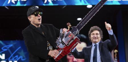 Elon Musk holds up a chainsaw he received from Argentina's President Javier Milei, right, as they arrive to speak at the Conservative Political Action Conference, CPAC, at the Gaylord National Resort & Convention Center, Thursday, Feb. 20, 2025, in Oxon Hill, Md. (AP Photo/Jose Luis Magana)