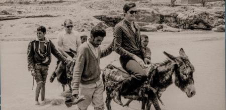 Turistes sobre ases acompanyats de gitanos, autoria desconeguda