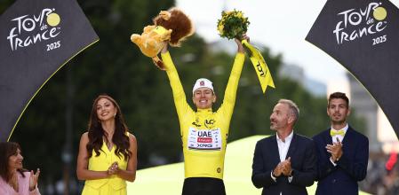 TOPSHOT - UAE Team Emirates - XRG team's Slovenian rider Tadej Pogacar celebrates on the podium with the overall leader's yellow jersey after the 21st and final stage of the 112th edition of the Tour de France cycling race, 132.3 km between Mantes-la-Ville and Paris Champs-Élysees, on July 27, 2025. (Photo by Anne-Christine POUJOULAT / AFP)