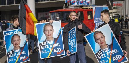BERLIN, GERMANY - FEBRUARY 22: AfD supporters hold placards of faction co-chairwoman and top candidate for the federal election Alice Weidel as they gather in Hohenschoenhausen district for a rally of the local chapter of the far-right Alternative for Germany (AfD) the day before national elections on February 22, 2025 in Berlin, Germany. The AfD is currently in second place in polls ahead of snap federal parliamentary elections scheduled for tomorrow. (Photo by Maja Hitij/Getty Images)