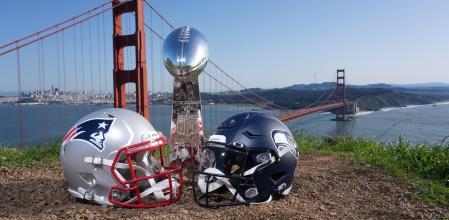 Jan 29, 2026; San Francisco, California, USA; New England Patriots and Seattle Seahawks helmets with a Vince Lombardi Super Bowl trophy at the Golden Gate bridge. Mandatory Credit: Kirby Lee-Imagn Images