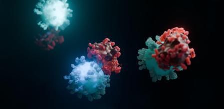 Imagen virtual de células CAR-T (azules y verdes) atacando células de cáncer (rojas)&nbsp;