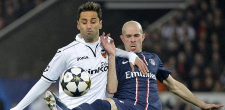 El jugador del París Saint-Germain, Christophe Jallet (dcha), pelea por el control del balón con el delantero del Valencia CF, Jonás, durante el partido de vuelta de los octavos de final de la Liga de Campeones disputado en el estadio Parque de los Príncipes de París, Francia, el 6 de marzo del 2013