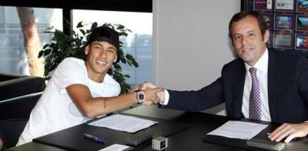 Neymar y Rosell se dan un apretón de manos, tras la firma de contrato del brasileño por el Barça