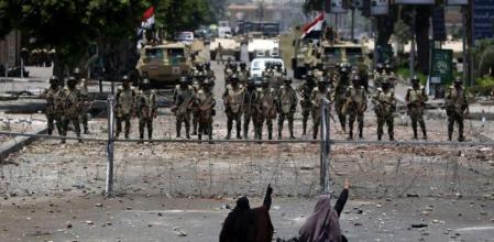Manifestantes a favor de Mohamed Morsi protestan ante una alambrada frente al cuartel de la Guardia Republicana de El Cairo