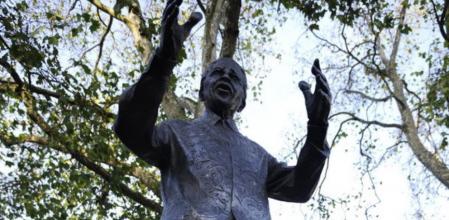 Flores y velas encendidas adornan una estatua del expresidente sudafricano Nelson Mandela en la Plaza del Parlamento en Londres (Reino Unido), hoy, viernes 6 de diciembre de 2013. Nelson Mandela falleció ayer a los 95 de edad. EFE/Facundo Arrizabalaga