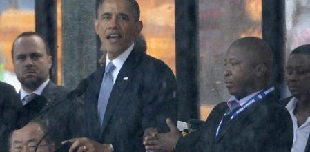 Barack Obama da su discurso en Soweto durante el funeral de Nelson Mandela mientras un falso intérprete gesticula a su lado
