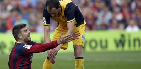 Pique gesticula ante Godín.