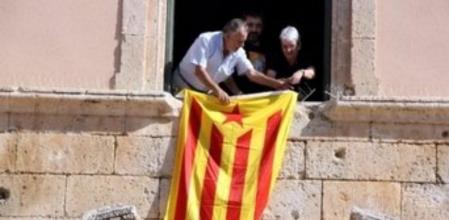 El alcalde en funciones de Torredembarra, Enric Grangel (PSC), en una imagen de archivo colgando la estelada en la fachada del Ayuntamiento