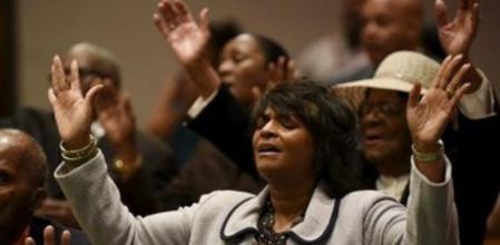Una mujer reza durante la plegaria del domingo en la iglesia baptista donde se ofició el funeral por Freddie Gray, el joven negro que murió en custodia policial en Baltimore