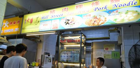 A customer (L) waits for food at the one star Michelin award Hill Street Tai Hwa Pork Noodle stall in Singapore on July 22, 2016. - Culinary bible Michelin on July 21 awarded one star each to two street food hawkers in Singapore, the first in the guide's history. Launching the inaugural restaurant and hotel guide to the Southeast Asian city-state, Michelin inspectors gave one star each to Hill Street Tai Hwa Pork Noodle and Hong Kong Soya Sauce Chicken Rice & Noodle. (Photo by ROSLAN RAHMAN / AFP)