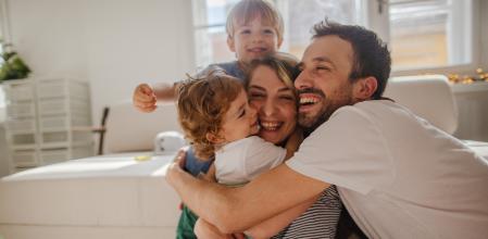 Shot of a father and son reading a book while relaxing on the sofa at home