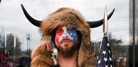 FILE PHOTO: Jacob Anthony Chansley, also known as Jake Angeli, of Arizona, poses with his face painted in the colors of the U.S. flag as supporters of U.S. President Donald Trump gather in Washington, U.S. January 6, 2021. REUTERS/Stephanie Keith/File Photo