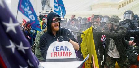 FILE - In this Jan. 6, 2021, file photo rioters loyal to President Donald Trump try to break through a police barrier at the Capitol in Washington. Arguments begin Tuesday, Feb. 9, in the impeachment trial of Donald Trump on allegations that he incited the violent mob that stormed the U.S. Capitol on Jan. 6. (AP Photo/John Minchillo, File)