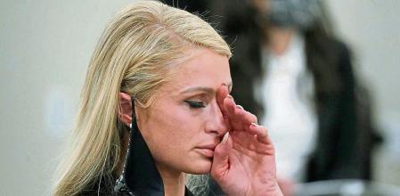 Paris Hilton wipes her eyes after speaking at a committee hearing at the Utah State Capitol, Monday, Feb. 8, 2021, in Salt Lake City. Hilton has been speaking out about abuse she says she suffered at a boarding school in Utah in the 1990s and she testified in front of state lawmakers weighing new regulations for the industry. (AP Photo/Rick Bowmer)