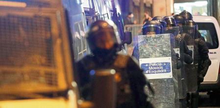 Police officers walk during a protest in support of Catalan rapper Pablo Hasel, after he was given a jail sentence on charges of glorifying terrorism and insulting royalty in his songs, in Barcelona, Spain, February 19, 2021. REUTERS/Albert Gea