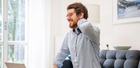 Young guy suffering from backache working from home