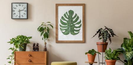 Stylish and vintage interior design of living room with retro furnitures and elegant personal accessories. Mock up poster frame. Template. Home decor.