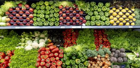 Verduras y frutas frescas en la sección refrigerada de un supermercado