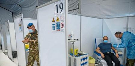 ROME, ITALY - MARCH 25: A man receives a dose of the AstraZeneca COVID-19 vaccine, at the vaccination hub in the military citadel of Cecchignola, on March 25, 2021 in Rome, Italy. At the request of the European Commission, Italian security forces discovered 29 million does of the AstraZeneca vaccine at a Catalent factory. Meanwhile European public trust dwindled with reported side effects of the AstraZeneca vaccine, a prosecutor in Italy is investigating possible manslaughter after a naval office died hours after being inoculated with the AstraZeneca vaccine. (Photo by Antonio Masiello/Getty Images)